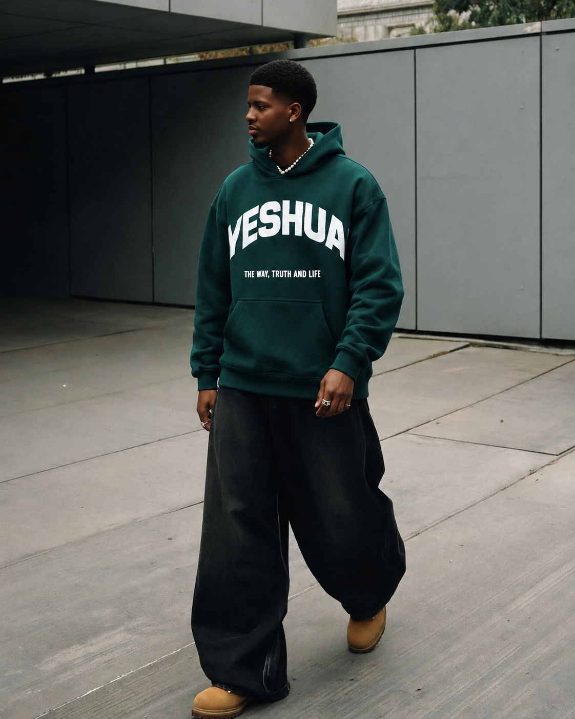Yeshua Hoodie in emerald green worn on the street